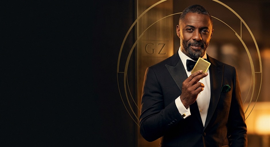 Stacks of colored poker chips and playing cards arranged on dark surface